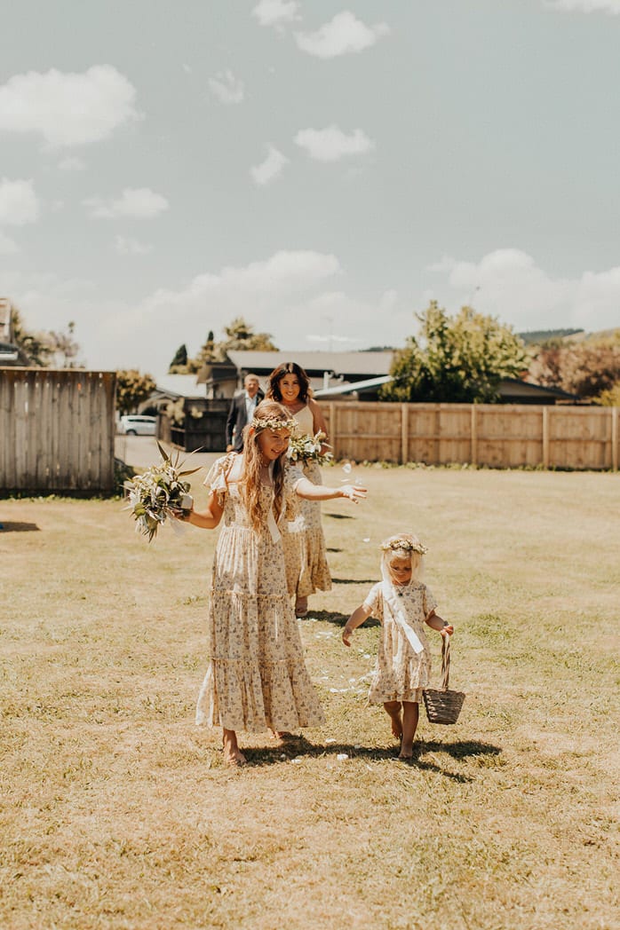 Nicole and Choppie - Gisborne Wedding captured by Oriwia Soutar.
Free spirit in her Daughters of Simone gown; a seventies silhouette, fluted sleeves. Bohemian bride. Featured on Wild Hearts, New Zealand. Flower girls. 