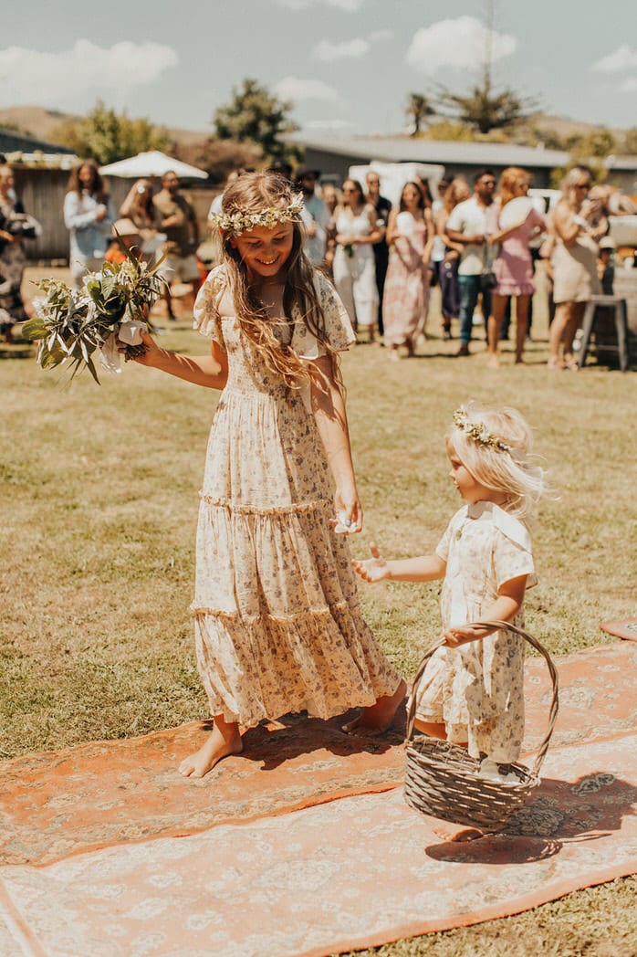Nicole and Choppie - Gisborne Wedding captured by Oriwia Soutar.
Free spirit in her Daughters of Simone gown; a seventies silhouette, fluted sleeves. Bohemian bride. Featured on Wild Hearts, New Zealand. Flower girls. 